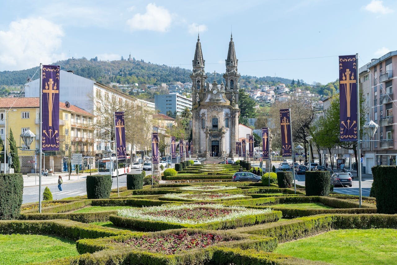 Explore the elegant architecture and landscaped gardens of Guimarães historic church in Portugal.